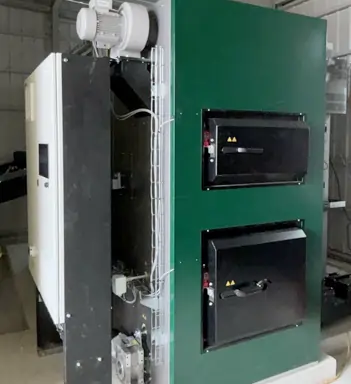 KWB Powerfire2 biomass boiler with automation cabinet installed on the side.